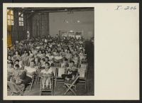 [recto] Closing of the Jerome Center, Denson, Arkansas. A view of the audience in the large, recently constructed recreation hall at ...