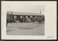 [recto] An exterior view of the motor and truck shop at this relocation center. ;  Photographer: Parker, Tom ;  Denson, Arkansas.