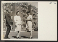 [recto] Mr. and Mrs. Misao Tajitsu, Issei from the Minidoka Relocation Center, are chatting in front of their New York City ...