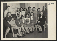 [recto] Shown is a group of FPHA employees. In the front row, left to right, there are two Nisei girls: Marie Kai (Granada) and Arrice Mizono (Topaz). Back row, left to right: Mae Tanaka (Topaz) and Helen Matsumoto (Poston). ;  Photographer: Iwasaki, Hikaru