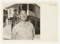 [recto] This picture shows Peter Osuga standing in front of Hostel No. 1, located at 327 O Street, Sacramento, California. Mr. ...