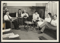 [recto] Group in the lounge of the Oakland Hostel at 797 10th Street, Oakland, California. Left to right, those shown are, ...