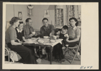 [recto] In his barracks home at block 7-21, Bill Hosokawa and his wife Alice serve oyster stew in an evening visit ...