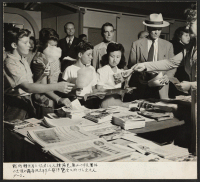[recto] Americans All booth at Pan-Pacific Industrial Exposition, Los Angeles, sponsored by anti-racial civic organizations in cooperation with W.R.A. (Continuous motion picture showing of Nisei in Action and World We Want to Live In.) ;  Photographer: Iwasaki,