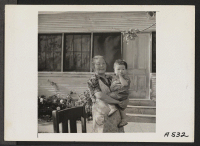 [recto] Grandmother and youngest of 13 grandchildren photographed during a pre-evacuation barbecue on a ranch in Santa Clara County, California. Evacuees of Japanese ancestry will be transferred later to War Relocation Authority centers for the duration. ;  Pho