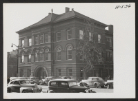 [recto] This is the Peoria Public Library building. Miss Irene Eiko Yonemura works here. She is from the Poston center and has been in Peoria since the summer of 1943. ;  Photographer: Mace, Charles E. ;  Peoria, Illinois.