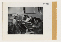 [recto] An evening class in the adult education section who are taking up second year German. Note that among the students of Japanese ancestry, there is also in regular attendance, a Caucasian grade school teacher. ;  Photographer: Parker, Tom ;  Amache, Col