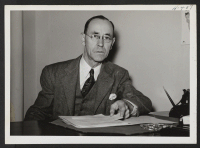 [recto] Joseph H. Hansen is the Assistant Relocation Officer for the State of Wisconsin with headquarters in Milwaukee. ;  Photographer: Mace, Charles E. ;  Milwaukee, Wisconsin.