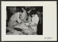 [recto] New Year's Fair. Kitchen crew making pies, which were sold to appreciative customers in kitchen, near the fair area. ;  Photographer: Stewart, Francis ;  Poston, Arizona.