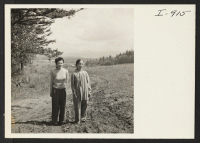 [recto] Mrs. Roy Yamada and her mother, Mrs. B. Fujii, in front of their home near Troutdale, Oregon. Roy Yamada is ...