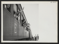 [recto] Handkerchiefs are waved and farewells called from the car windows as a train leaves the Tule Lake Center to carry transferees to their new homes. ;  Photographer: Mace, Charles E. ;  Newell, California.