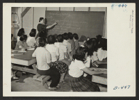 [recto] Group picture of a class with the instructor at the blackboard giving lecture on dehydration. ;  Photographer: Stewart, Francis ;  Rivers, Arizona.