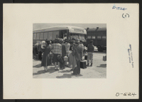 [recto] Lone Pine, Calif.--Evacuees from Sacramento to change from the train to a bus on their trip to the Manzanar War Relocation Authority center where they will spend the duration. ;  Photographer: Stewart, Francis ;  Manzanar, California.