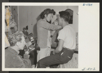 [recto] Peter O'Crotty, photographer for OWI overseas, pictures actors making-up before putting on a stage show. ;  Photographer: Stewart, Francis ;  Newell, California.