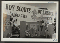 [recto] Exhibits of work done by the various boy scout troops at Granada. ;  Photographer: McClelland, Joe ;  Amache, Colorado.