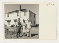 [recto] Left to right: Tay Andow, Mrs. Yoshi Andow, his wife, and Aya Nakashima at the Andow home at Route 1, ...