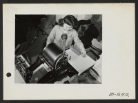 [recto] Rose Nakagawa, former student from San Francisco, California, now works as a mimeograph operator on the Topaz Times. ;  Photographer: Stewart, Francis ;  Topaz, Utah.