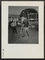 [recto] Evacuees from Hawaii were transported from Delta, Utah, to this center on army trucks. A reception was held by the other residents in honor of the newly arrived. ;  Photographer: Stewart, Francis ;  Topaz, Utah.
