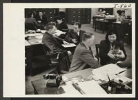 [recto] A scene in the Chicago Relocation Division of the War Relocation Authority where relocatees are being interviewed for relocation and assistance. ;  Photographer: Iwasaki, Hikaru ;  Chicago, Illinois.