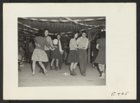 [recto] Junior high school students at their first social hour cut loose with a bit of rug cutting. ;  Photographer: Parker, Tom ;  Amache, Colorado.