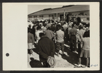 [recto] An evacuee resident, who is a Christian Minister, opens the hospital dedication with a moving prayer. ;  Photographer: Parker, Tom ;  Topaz, Utah.