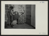 [recto] View in the home of Eizo Nishi, showing attractive way this evacuee family has decorated their barrack apartment. Present occupation: none. Former occupation: hotel business. Former residence: Seattle, Washington. ;  Photographer: Stewart, Francis ;