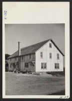 [recto] New dormitory with quarters for both married and single evacuees now nearing completion on one of the Curtiss Candy Company's farms near Marengo, Illinois. Eighteen former residents of War Relocation Centers are now employed on the company's farms. ;  P
