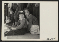 [recto] Manzanar, Calif.--Little evacuees of Japanese descent watch Memorial Day services. Evacuee Boy Scouts took a leading part in the ceremony held at this War Relocation Authority center. ;  Photographer: Stewart, Francis ;  Manzanar, California.