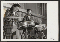 [recto] A snare drum section of the high school band, in a practice session. Most of the student band members are ...
