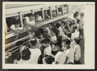 [recto] Closing of the Jerome Center, Denson, Arkansas. Students of the Denson High School who are to be moved to distant centers, say goodbye to their classmates who are being taken by bus to the Rohwer Center. ;  Photographer: Mace, Charles E. ;  Denson, Ar