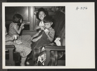 [recto] Meals served passengers travelling to and from Tule Lake were excellent. Between meals, ice cream and lemonade were frequently distributed through the coaches. Children of Japanese ancestry go for ice cream as eagerly as Caucasians, as here evidenced.