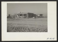 [recto] Press Club building. This structure was erected by members of the Poston Daily Chronicle. It was made from materials and adobe which was made by staff members. ;  Photographer: Stewart, Francis ;  Poston, Arizona.