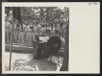 [recto] The Mormon choir sings Come, Come Ye Saints during services in the third battalion amphitheater. Chaplain Thomas Eugene West at ...