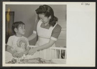 [recto] Six-year-old Reiko Masado, convalescing from a serious illness, is looked after by nurse's aid, Chiyo Okata. All functions of the ...