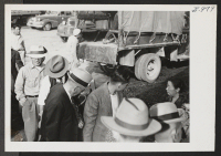 [recto] A group of the 254 evacuees transferred from the Minidoka Relocation Center to the Tule Lake Center boards the train at Hunt siding after riding the five miles from the center in trucks. ;  Hunt, Idaho.