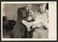 [recto] Announcer Chet Huntley of the CBS interviewing Ellis Georgia, WRA area engineer, in a nationwide hookup. ;  Photographer: Clark, Fred ;  Poston, Arizona.