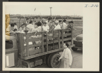 [recto] Closing of the Jerome Center, Denson, Arkansas. A typical truck load of evacuees waiting to board the [illegible] for other locations. ;  Photographer: Iwasaki, Hikaru ;  Denson, Arkansas.