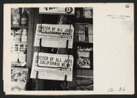 [recto] Headlines of newspapers, in stand at 14th and Broadway, presaged on February 27, 1942, the evacuation of persons of Japanese ...