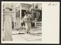 [recto] Mrs. Shigeko Sakamoto sweeps the terrace at the home of Mrs. H. D. Warner in Fairfield, Connecticut, where she and ...