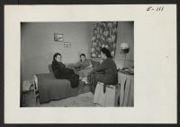 [recto] Future Caucasian teachers and administration staff. Single dormitory wings are provided for the single people. A group of administrative workers and teachers gather for a bit of relaxation after a busy day. ;  Photographer: Parker, Tom ;  Heart Mounta