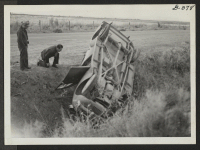 [recto] A flat tire proved the undoing of this WRA passenger car at the Central Utah Relocation Center. The car loaded ...