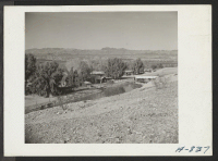 [recto] In the foreground can be seen the irrigation canal which will supply Poston with agricultural water. This canal receives its water from the Parker Dam. In the background can be seen the Colorado River. ;  Photographer: Stewart, Francis ;  Poston, Ariz