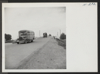 [recto] A caravan of buses is seen on the highway between Topaz Center and Delta, Utah, conveying transferees to the latter place where they are to be entrained for the Tule Lake Center. ;  Photographer: Mace, Charles E. ;  Topaz, Utah.