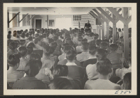 [recto] Captain William S. Fairchild, of a special United States Army Recruiting team, addressing a group meeting of young Japanese-Americans between ...