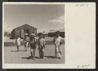 [recto] Manzanar, Calif.--Pre-school children on the way to their barrack homes from morning class at this War Relocation Authority center for evacuees of Japanese ancestry. ;  Photographer: Lange, Dorothea ;  Manzanar, California.