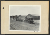 [recto] Poston, Ariz.--Site No. 2--Leveling the streets with tractors at this War Relocation Authority center for evacuees of Japanese ancestry. ;  Photographer: Clark, Fred ;  Poston, Arizona.