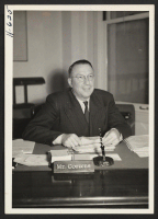 [recto] R. B. Cozzens, Assistant Director, WRA, is shown at his desk in the San Francisco Office of the WRA. ;  Photographer: Mace, Charles E. ;  San Francisco, California.