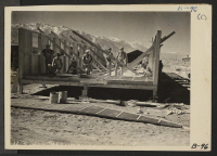 [recto] Manzanar, Calif.--Constructing quarters for evacuees of Japanese ancestry at this War Relocation Authority center in Owens Valley in the shadow of the High Sierras. ;  Photographer: Albers, Clem ;  Manzanar, California.