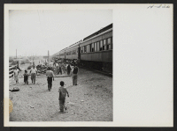 [recto] Time out for exercising. Each segregation train, when possible, paused for 10 or 15 minutes at some railroad siding to allow the passengers to detrain and limber up. ;  Photographer: Mace, Charles E. ; , .