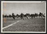 [recto] Over the line for a touchdown for Topaz in football game between Topaz and Fillmore high schools at Topaz Relocation Center on November 11, 1943. The score favored Topaz. ;  Topaz, Utah.